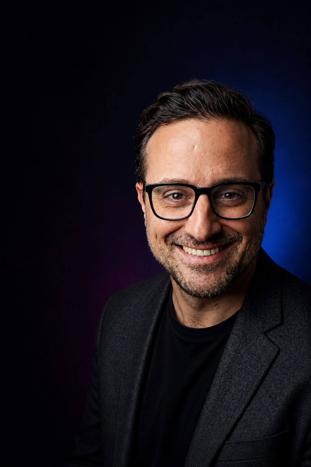 Nicolas Estrem smiling in a dark jacket.